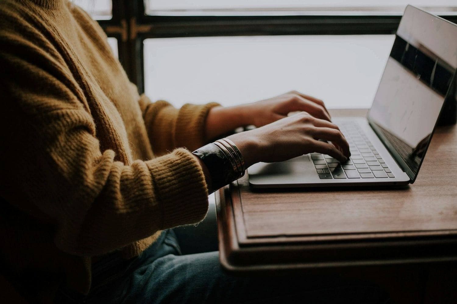 A person at a laptop, writing a reply